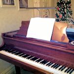 Cherry piano with bronze lamp
